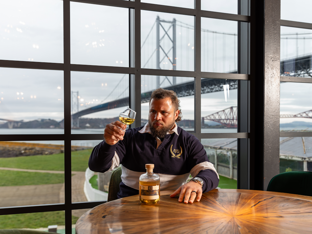 man drinking buzzworks whisky image